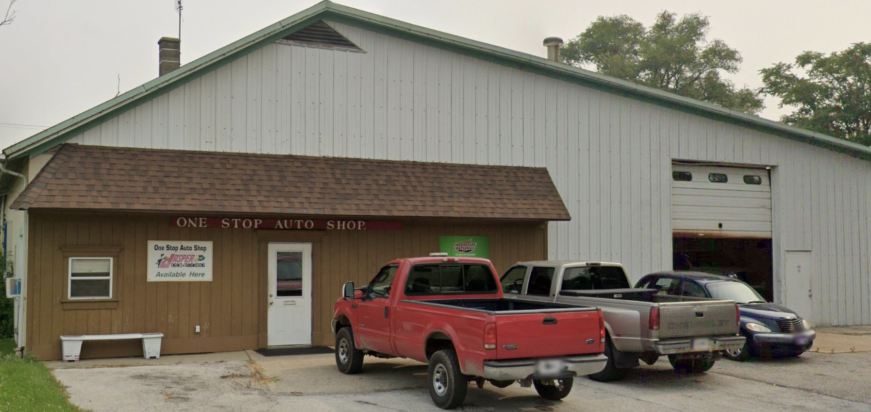 One Stop Auto Shop exterior in Columbia City, Indiana, with a red pickup truck parked out front